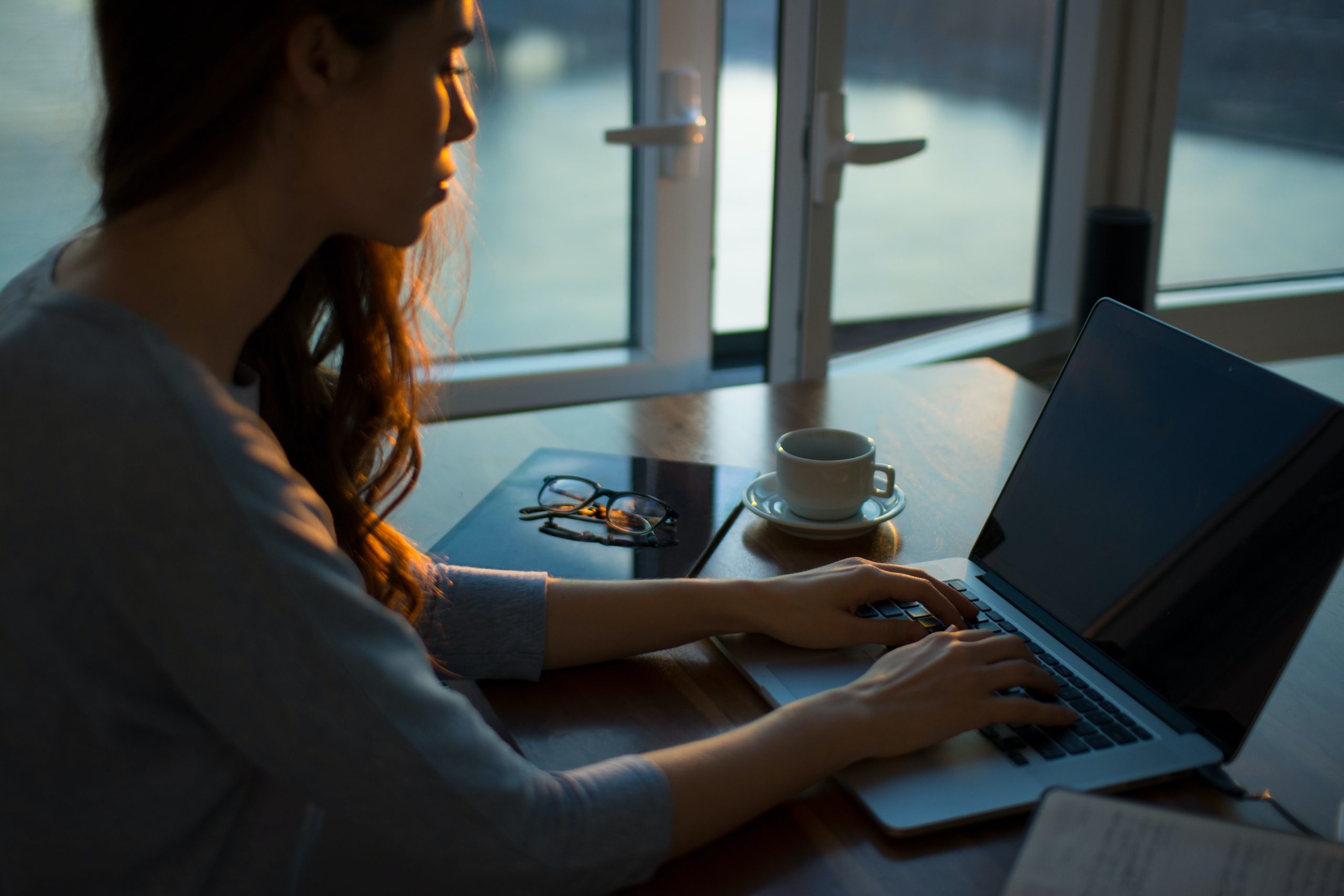 A girl on laptop Writing a Research Design Dissertation